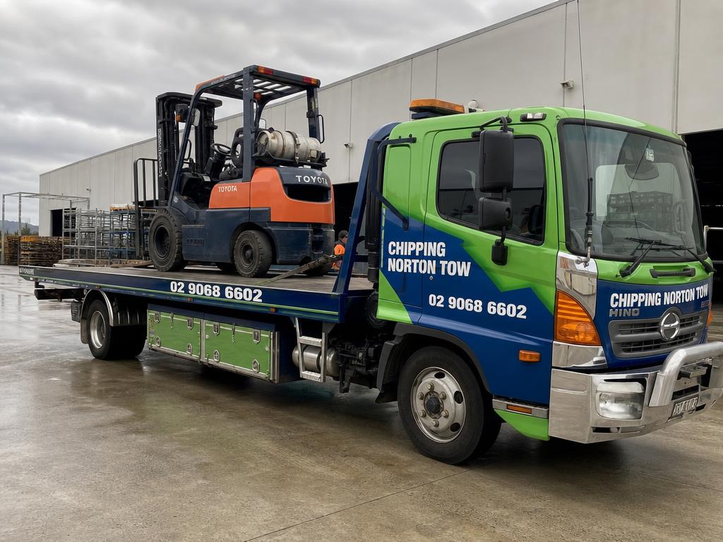 Forklift loaded on a Chipping Norton Tow heavy flatbed truck